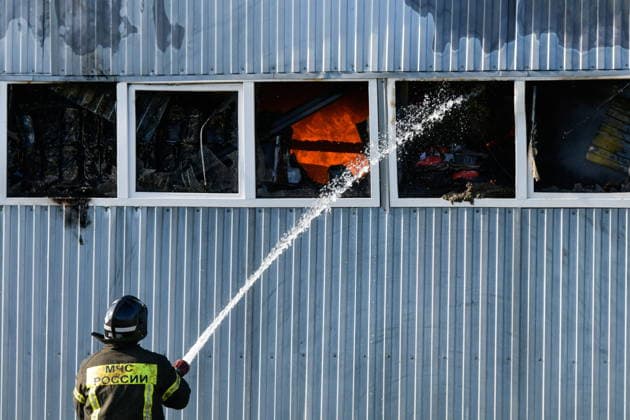 RUSSIA, KRASNODAR REGION - AUGUST 12, 2026: An employee of the Russian Emergencies Minsitry extinguishes a fire at a warehouse storing plastic products in the village of Lenina, southeast of Krasnodar. The fire covering an area of 2.2 thousand sq m has been contained Russia  - ZUMAt113 20260812_zaa_t113_350 Copyright: xRomanxSokolovx