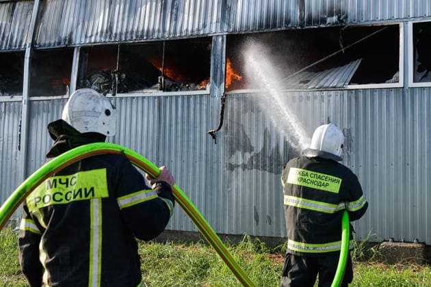 RUSSIA, KRASNODAR REGION - AUGUST 12, 2026: Employees of the Russian Emergencies Minsitry respond to a fire at a warehouse storing plastic products in the village of Lenina, southeast of Krasnodar. The fire covering an area of 2.2 thousand sq m has been contained Russia  - ZUMAt113 20260812_zaa_t113_353 Copyright: xRomanxSokolovx