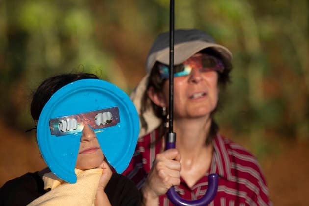 August 12, 2026, Sahagun, Spain: A woman and her daughter, wearing eclipse glasses, observer the sky during a total solar eclipse in a sunflower field in the town of Sahagun, Castile and Leon. Sahagun Spain - ZUMAs197 20260812_aaa_s197_131 Copyright: xLuisxSotox