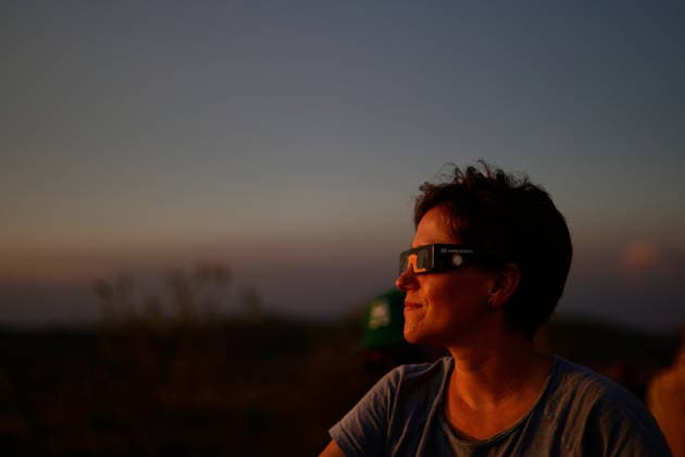 The Perfect Alignment Of The Moon And The Sun During The Total Solar Eclipse Of 2026 A woman wearing solar eclipse glasses gazes up at the total solar eclipse above the rugged mountain landscape of Horta de Sant Joan, with the glowing solar corona illuminating the dark twilight sky over the mountain peaks of Els Ports Natural Park during the eclipse in Horta de Sant Joan, Spain, on August 12, 2026. Horta de Sant Joan Catalonia Spain  Copyright: xJoanxCrosx originalFilename: cros-notitle260812_np0Dq.jpg