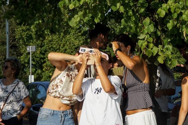 August 12, 2026, Torino, Italy: TURIN, ITALY Ã¢â‚¬ AUGUST 12, 2026: Hundreds of people gather in front of the Basilica of Superga, one of Turin s highest viewpoints, to observe a partial solar eclipse at sunset on August 12, 2026. Spectators used eclipse glasses and other viewing devices as the Moon obscured most of the solar disc, with the phenomenon reaching its maximum visible phase in the Turin area at around 8:30 p.m. Torino Italy - ZUMAq101 20260812_zna_q101_223 Copyright: xChiaraxAntenuccix