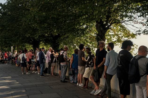 August 12, 2026, Torino, Italy: TURIN, ITALY Ã¢â‚¬ AUGUST 12, 2026: Hundreds of people gather in front of the Basilica of Superga, one of Turin s highest viewpoints, to observe a partial solar eclipse at sunset on August 12, 2026. Spectators used eclipse glasses and other viewing devices as the Moon obscured most of the solar disc, with the phenomenon reaching its maximum visible phase in the Turin area at around 8:30 p.m. Torino Italy - ZUMAq101 20260812_zna_q101_225 Copyright: xChiaraxAntenuccix
