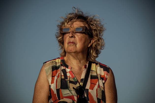 August 12, 2026, Ciutadella, Balearic Islands Menorca, Spain: A spectator wearing protective glasses watches a total solar eclipse at Punta Nati on the Spanish Balearic island of Menorca. Ciutadella Spain - ZUMAo105 20260812_fap_o105_003 Copyright: xMatthiasxOesterlex
