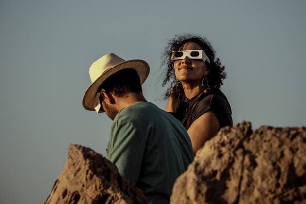 August 12, 2026, Ciutadella, Balearic Islands Menorca, Spain: A woman wearing protective glasses watches a total solar eclipse at Punta Nati on the Spanish Balearic island of Menorca. Ciutadella Spain - ZUMAo105 20260812_fap_o105_008 Copyright: xMatthiasxOesterlex