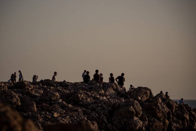 August 12, 2026, Ciutadella, Balearic Islands Menorca, Spain: People gather on the rocky coast to watch a total solar eclipse at Punta Nati on the Spanish Balearic island of Menorca. Ciutadella Spain - ZUMAo105 20260812_fap_o105_016 Copyright: xMatthiasxOesterlex