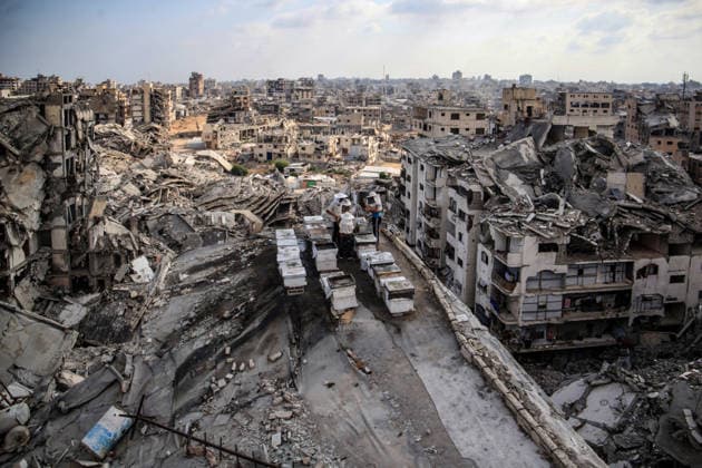 (260812) -- GAZA, Aug. 12, 2026 -- Sons of Palestinian beekeeper Ibrahim al-Dabba, tend to beehives on the roof of a destroyed building in Gaza City s Tel al-Hawa area, Aug. 10, 2026. Before the war, al-Dabba owned more than 400 beehives spreading across eastern Gaza. Gaza s Ministry of Agriculture said the war had damaged around 28,400 beehives across the Strip. (Photo by Xinhua) MIDEAST-GAZA CITY-BEE KEEPER RizekxAbdeljawad 