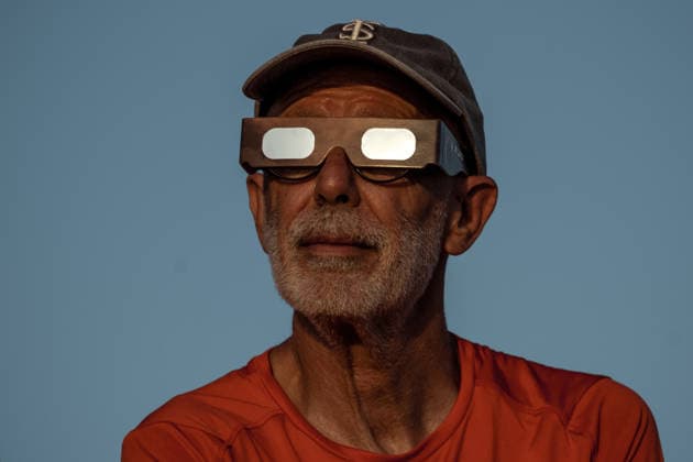 August 12, 2026, Ciutadella, Balearic Islands Menorca, Spain: A spectator wearing protective glasses watches a total solar eclipse at Punta Nati on the Spanish Balearic island of Menorca. Ciutadella Spain - ZUMAo105 20260812_fap_o105_023 Copyright: xMatthiasxOesterlex