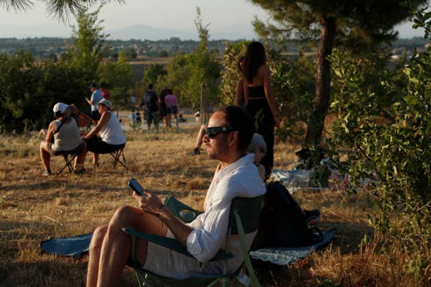 August 12, 2026, Madrid, Community Of Madrid, Spain: A massive crowd of astronomy enthusiasts and families gathers in the elevated grounds of the Parque Forestal de Valdebebas Felipe VI in Madrid, united by the anticipation of the first total solar eclipse visible from the Spanish mainland in 114 years. As the historic celestial event reaches its peak, the atmosphere in the park remains focused and disciplined; attendees are seen equipped with government-distributed, ISO 12312-2 certified solar glasses to safely observe the Sun s occlusion by the Moon. The choice of this expansive public park, with its unobstructed horizon and minimal urban light pollution, offers thousands of spectators a prime vantage point to witness the transition of da - ZUMAo127 20260812_zep_o127_072 Copyright: xHugoxOrtunox