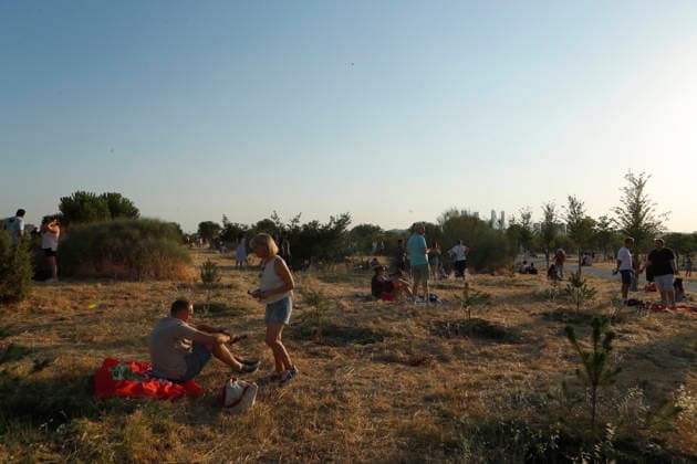 August 12, 2026, Madrid, Community Of Madrid, Spain: A massive crowd of astronomy enthusiasts and families gathers in the elevated grounds of the Parque Forestal de Valdebebas Felipe VI in Madrid, united by the anticipation of the first total solar eclipse visible from the Spanish mainland in 114 years. As the historic celestial event reaches its peak, the atmosphere in the park remains focused and disciplined; attendees are seen equipped with government-distributed, ISO 12312-2 certified solar glasses to safely observe the Sun s occlusion by the Moon. The choice of this expansive public park, with its unobstructed horizon and minimal urban light pollution, offers thousands of spectators a prime vantage point to witness the transition of da - ZUMAo127 20260812_zep_o127_076 Copyright: xHugoxOrtunox