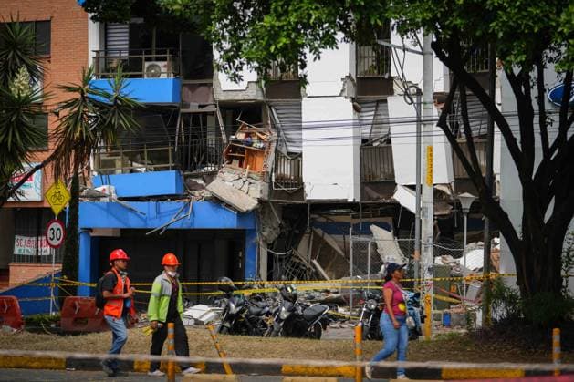 (260812) -- CALI, Aug. 12, 2026 -- People walk in front of a damaged building in an earthquake in Cali, Colombia on Aug. 12, 2026. The death toll from Monday s 7.4-magnitude earthquake in western Colombia has risen to 241, with 3,771 others injured, Colombian media reported Wednesday, citing figures from the National Unit for Disaster Risk Management. (Photo by Xinhua) COLOMBIA-CALI-EARTHQUAKE-AFTERMATH AndresxMoreno 