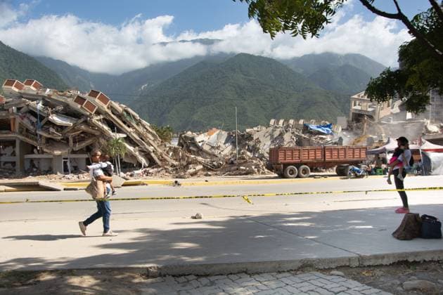 Recovery Efforts Continue in Earthquake-Ravaged La Guaira LA GUAIRA, VENEZUELA AUGUST 12, 2026: Residents continue moving through earthquake-damaged neighborhoods in Tanaguarena, Los Corales and Catia La Mar, where destroyed roads, collapsed buildings and debris continue to disrupt daily life 49 days after the twin earthquakes struck Venezuela s central coast. With public transportation limited, residents walk through rubble and around heavy machinery to reach different parts of the affected areas, while many continue searching for drinking water as recovery and debris removal operations remain underway. Estado la guaira Venezuela (Bolivarian Republic of) Copyright: x xFranyerxNievesx(Babel)x xJNAxPressx