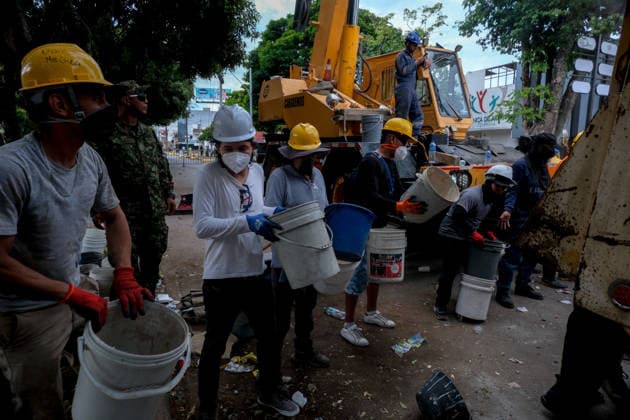 August 12, 2026, Cali, Valle Del Cauca, Colombia: People gather outside collapsed buildings in Cali, Colombia on August 12, 2026 to aid in several rescue labors after a 7,4 magnitude earthquake that struck the cities of Quibdo, Cali, Pereira and Manizales leaving more than 200 casualties past august 10. Cali Colombia - ZUMAvp1_ 20260812_zia_vp1_008 Copyright: xMartinxStevenxAngelx