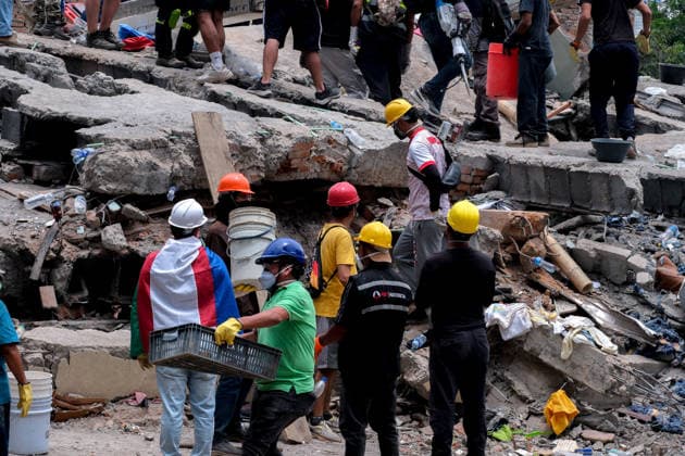 August 12, 2026, Cali, Valle Del Cauca, Colombia: People gather outside collapsed buildings in Cali, Colombia on August 12, 2026 to aid in several rescue labors after a 7,4 magnitude earthquake that struck the cities of Quibdo, Cali, Pereira and Manizales leaving more than 200 casualties past august 10. Cali Colombia - ZUMAvp1_ 20260812_zia_vp1_025 Copyright: xMartinxStevenxAngelx