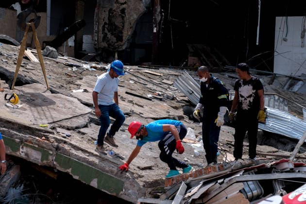 August 12, 2026, Cali, Valle Del Cauca, Colombia: People gather outside collapsed buildings in Cali, Colombia on August 12, 2026 to aid in several rescue labors after a 7,4 magnitude earthquake that struck the cities of Quibdo, Cali, Pereira and Manizales leaving more than 200 casualties past august 10. Cali Colombia - ZUMAvp1_ 20260812_zia_vp1_033 Copyright: xMartinxStevenxAngelx
