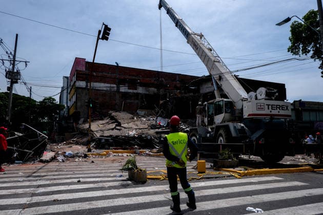 August 12, 2026, Cali, Valle Del Cauca, Colombia: People gather outside collapsed buildings in Cali, Colombia on August 12, 2026 to aid in several rescue labors after a 7,4 magnitude earthquake that struck the cities of Quibdo, Cali, Pereira and Manizales leaving more than 200 casualties past august 10. Cali Colombia - ZUMAvp1_ 20260812_zia_vp1_035 Copyright: xMartinxStevenxAngelx