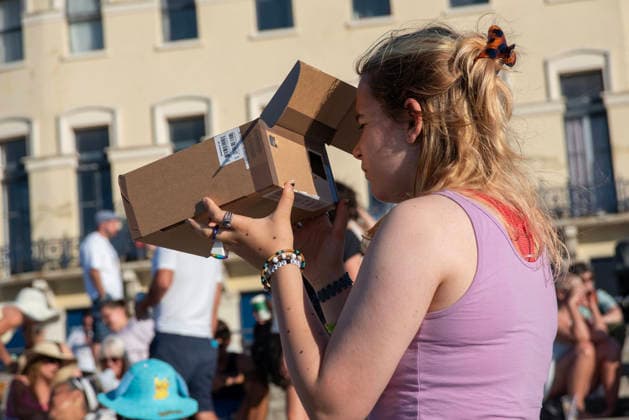 Solar Eclipse 2026 in Margate, UK - 12 AUG 2026. A woman seen enjoying the solar eclipse using her home made pinhole projector . Hundreds of people gathered on the King s Steps to enjoy the partial solar eclipse in Margate, UK. Because of the Sun was covered by the Moon 90.6% on the maximum phase of the partial solar eclipse. Margate United Kingdom Copyright: xKrisztianxElekx xSOPAxImagesx SSS_20260812_SOLAR_ECLIPSE_0011005026