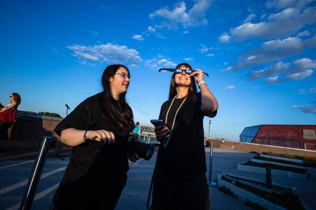 Polish Prime Minister, Donald Tusk joins observers to watch partial solar eclipse in Warsaw, Poland - 12 AUG 2026. Two women seen enjoying the solar eclipse. On the evening of the 12th August, Prime Minister of the Republic of Poland, Donald Tusk, joins scientific observers and members of the public at the Copernicus Science Centre in Warsaw to watch a partial solar eclipse. At its maximum, the Moon obscures about 82% of the Sun as viewed from the Polish capital. Warsaw’s eclipse runs from approximately 19:14 until sunset at 20:06, reaching its maximum at 20:02. The roughly 82% figure refers to the Sun’s covered area; the eclipse magnitude was about 0.85. Warsaw Poland Copyright: xNeilxMiltonx xSOPAxImagesx NSM2026168G0812-L1003236_5000_300dpi