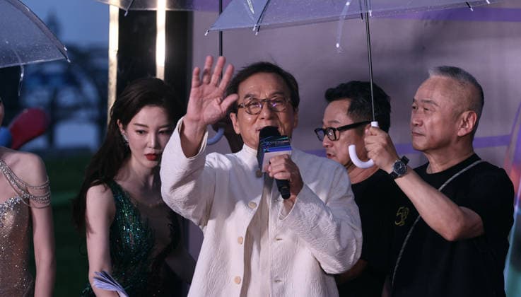 HARBIN, CHINA - AUGUST 12: Director Chen Deshen holds an umbrella for Jackie Chan on the red carpet during the closing ceremony of the 7th Jackie Chan International Action Film Week on August 12, 2026 in Harbin, Heilongjiang Province of China.  Copyright: xVCGx 111659586559