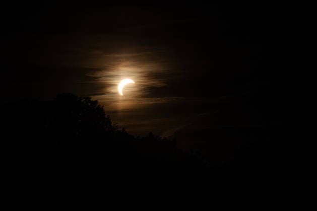 August 12, 2026, Leipzig, Sachsen, Germany: The Moon begins to cover the Sun during a partial solar eclipse, seen through clouds over Leipzig. Residents gathered in the evening to observe the Moon move across the face of the Sun. The eclipse began at 7:17 p.m. CEST and reached its maximum over the city at 8:10 p.m. Leipzig Germany - ZUMAs197 20260812_aaa_s197_253 Copyright: xVasilyxKrestyaninovx