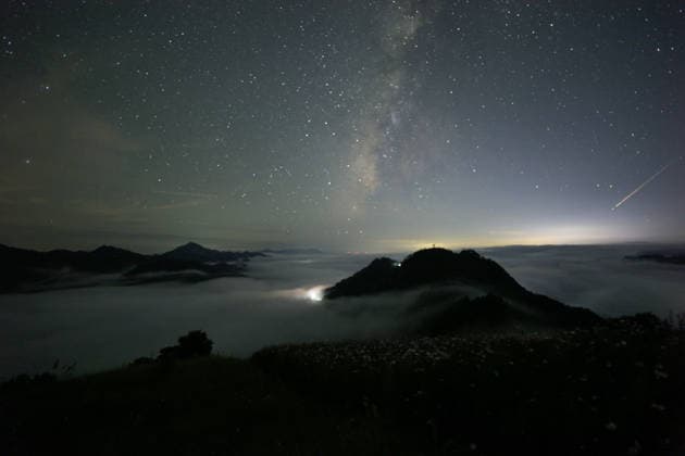 SHExian, CHINA - AUGUST 13: The Perseid meteor shower lights up the night sky over Shitan Village in Xiekeng Town on August 13, 2026 in Shexian, Anhui Province of China. The Perseid meteor shower will be visible on Wednesday night and before dawn Thursday morning, reaching its expected peak -- or point of maximum meteor activity -- on Thursday at 10:53 a.m. ET, according to EarthSky.  Copyright: xVCGx 111659677193