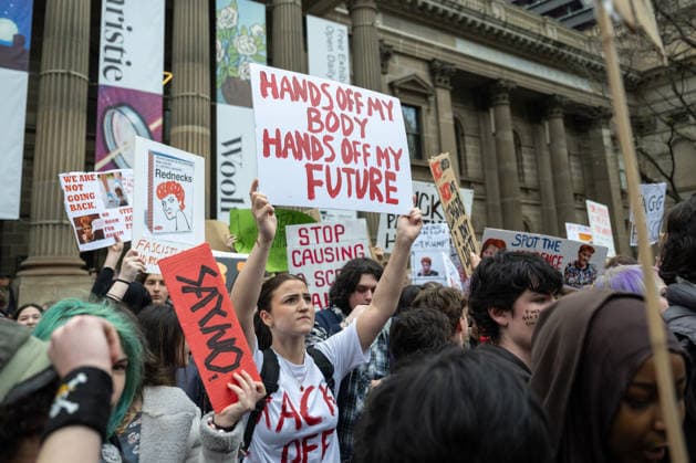 ONE NATION STUDENT PROTEST, A student holds a sign during a rally of high school and university students opposed to the policies of Pauline Hanson and One Nation at State Library Victoria in Melbourne, Thursday, August 13, 2026. ( NO ARCHIVING Melbourne Victoria AUSTRALIA  Copyright: xJAYxKOGLERx 20260813194856933156