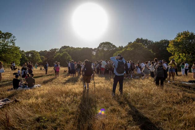 Solar Eclipse Over Hampstead Heath London, 2026 Visitors gathered at Hampstead Heath in North London to watch the solar eclipse. The eclipse was visible across the London skyline, with spectators looking towards the sky and capturing the event on cameras and phones., Credit:Zak Irfan Avalon  Copyright: xZakxIrfanx xAvalonx 1122596874