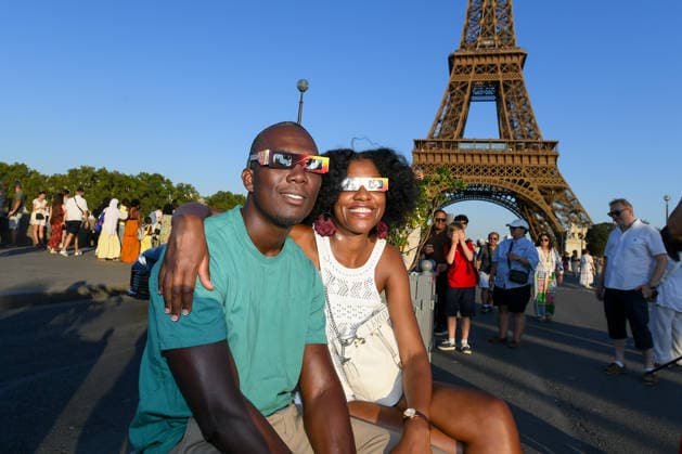 Paris: The public watches the solar eclipse. People near the Eiffel Tower watch through solar eclipse viewing glasses as the moon completely passes over the sun s horizon during a partial solar eclipse in Paris on August 12, 2026. 458857 2026 08 12 Paris, France (no people)  Copyright: xL.Urmanx xStarfacex STAR_458857_018