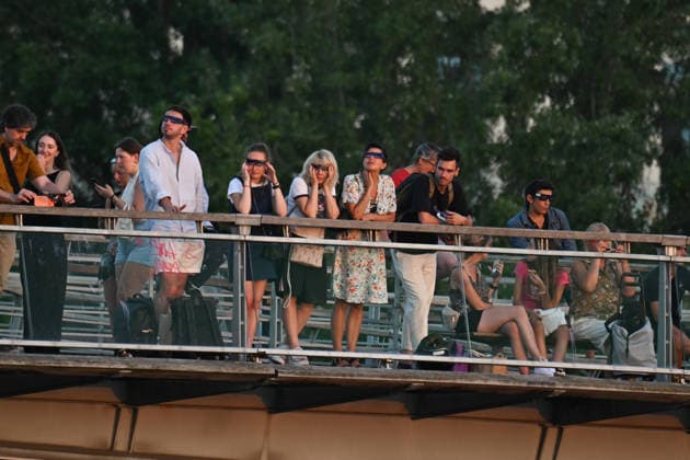 Paris: People on the Léopold Sédar Senghor Footbridge watch the solar eclipse using solar eclipse viewing glasses as the moon completely passes over the sun’s horizon during a partial solar eclipse in Paris on August 12, 2026 458857 2026 08 12 Paris, France, no people  Copyright: xL.Urmanx xStarfacex STAR_458857_022