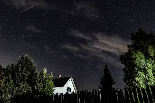 RUSSIA, MOSCOW REGION - AUGUST 13, 2026: A Perseid crosses the night sky over a house. Sergei Savostyanov TASS  96092845