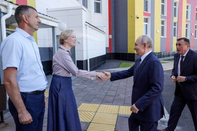 RUSSIA, SAKHALIN REGION - AUGUST 13, 2026: Valery Limarenko, Sakhalin Region Governor, and Vladimir Putin (R-L), President of Russia, visit Hero of Russia Eduard Norpolov secondary school in Kurilsk, Iturup Island. Gavriil Grigorov Russian Presidential Press and Information Office TASS  96092769