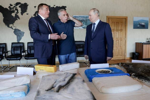 RUSSIA, SAKHALIN REGION - AUGUST 13, 2026: Alexander Verkhovsky (C), President of Gidrostroy, accompanies Valery Limarenko (R), Sakhalin Region Governor, and Vladimir Putin, President of Russia, on their visit to the Yasny Clear fish processing plant owned by Gidrostroy and situated on Iturup Island. Gavriil Grigorov Russian Presidential Press and Information Office TASS  96092644