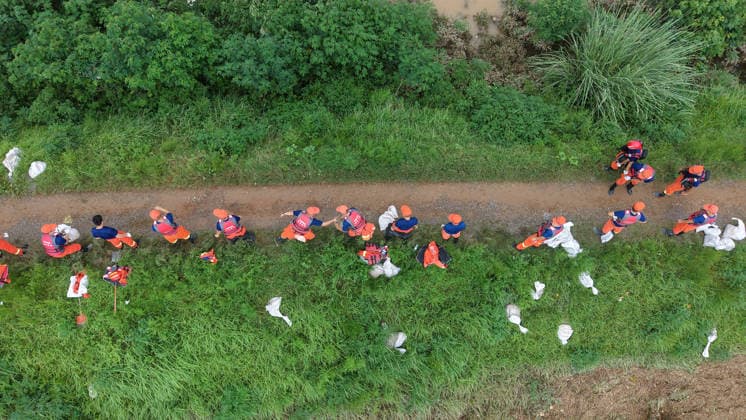 (260813) -- PINGDINGSHAN, Aug. 13, 2026 -- An aerial drone photo shows repair work underway at the site of a levee breach along the Beiru River in Jiaxian County, central China s Henan Province, Aug. 13, 2026. Thousands of people have been evacuated in Henan Province after days of torrential rain swelled rivers and triggered a levee breach, local authorities said Thursday. In Pingdingshan City, more than 2,000 people were relocated to safety after a levee along the Beiru River in Jiaxian County gave way on Wednesday night, following extreme rainfall and large-volume discharges from upstream reservoirs. No casualties have been reported so far. ) CHINA-HENAN-PINGDINGSHAN-LEVEE BREACH-REPAIR WORK (CN) YangxJinxin 