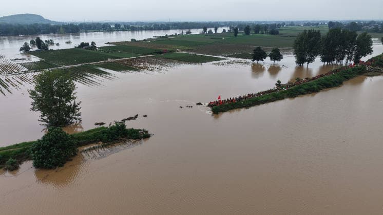 (260813) -- PINGDINGSHAN, Aug. 13, 2026 -- An aerial drone photo shows repair work underway at the site of a levee breach along the Beiru River in Jiaxian County, central China s Henan Province, Aug. 13, 2026. Thousands of people have been evacuated in Henan Province after days of torrential rain swelled rivers and triggered a levee breach, local authorities said Thursday. In Pingdingshan City, more than 2,000 people were relocated to safety after a levee along the Beiru River in Jiaxian County gave way on Wednesday night, following extreme rainfall and large-volume discharges from upstream reservoirs. No casualties have been reported so far. ) CHINA-HENAN-PINGDINGSHAN-LEVEE BREACH-REPAIR WORK (CN) YangxJinxin 