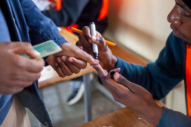 (260813) -- LUSAKA, Aug. 13, 2026 -- A staff member inks a mark on a voter s thumb for preventing multiple voting at a polling station in Lusaka, Zambia, on Aug. 13, 2026. Zambia held general elections on Thursday, with about 8.7 million registered voters casting ballots for president, National Assembly members and local representatives. (Photo by Xinhua) ZAMBIA-GENERAL ELECTIONS-VOTING MartinxMbangweta 