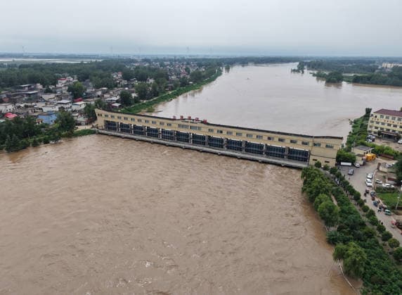 (260813) -- LUOHE, Aug. 13, 2026 -- An aerial drone photo taken on Aug. 13, 2026 shows a flood discharge scene at the Nihewa flood storage and detention area in Wuyang County of Luohe City, central China s Henan Province. Affected by Typhoon Dolphin, the 13th typhoon of the year, the Shaying River has recorded a flow rate exceeding 3,000 cubic meters per second in its Luohe section, while the water level continues to rise. In accordance with relevant contingency plans, Henan Province activated the Nihewa flood storage and detention area on Thursday. ) CHINA-HENAN-LUOHE-TYPHOON DOLPHIN-FLOOD STORAGE AREA (CN) HaoxYuan 