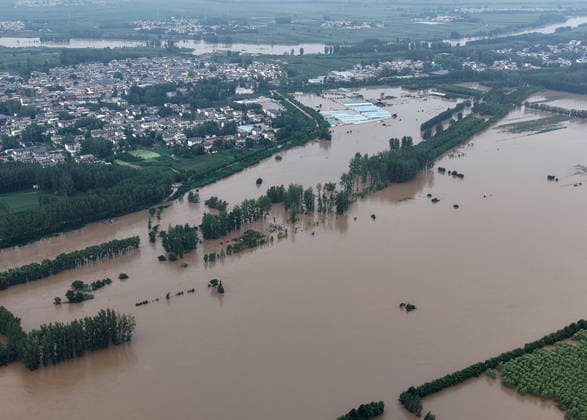 (260813) -- LUOHE, Aug. 13, 2026 -- An aerial drone photo taken on Aug. 13, 2026 shows the Nihewa flood storage and detention area in Wuyang County of Luohe City, central China s Henan Province. Affected by Typhoon Dolphin, the 13th typhoon of the year, the Shaying River has recorded a flow rate exceeding 3,000 cubic meters per second in its Luohe section, while the water level continues to rise. In accordance with relevant contingency plans, Henan Province activated the Nihewa flood storage and detention area on Thursday. ) CHINA-HENAN-LUOHE-TYPHOON DOLPHIN-FLOOD STORAGE AREA (CN) HaoxYuan 
