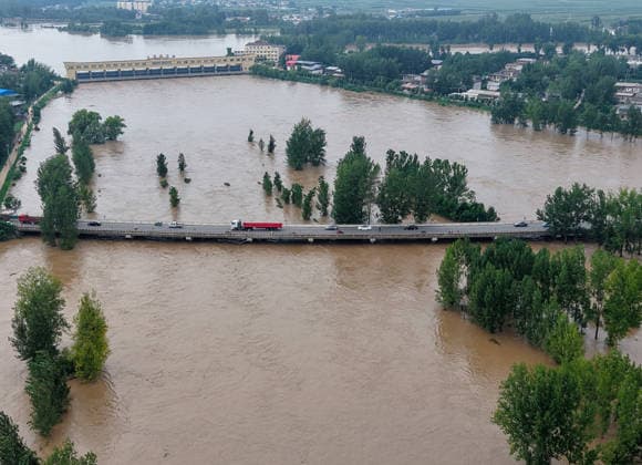 (260813) -- LUOHE, Aug. 13, 2026 -- An aerial drone photo taken on Aug. 13, 2026 shows the Nihewa flood storage and detention area in Wuyang County of Luohe City, central China s Henan Province. Affected by Typhoon Dolphin, the 13th typhoon of the year, the Shaying River has recorded a flow rate exceeding 3,000 cubic meters per second in its Luohe section, while the water level continues to rise. In accordance with relevant contingency plans, Henan Province activated the Nihewa flood storage and detention area on Thursday. ) CHINA-HENAN-LUOHE-TYPHOON DOLPHIN-FLOOD STORAGE AREA (CN) HaoxYuan 