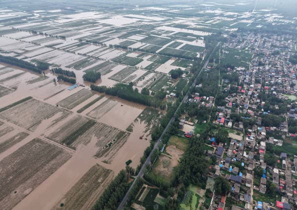 (260813) -- LUOHE, Aug. 13, 2026 -- An aerial drone photo taken on Aug. 13, 2026 shows the Nihewa flood storage and detention area in Wuyang County of Luohe City, central China s Henan Province. Affected by Typhoon Dolphin, the 13th typhoon of the year, the Shaying River has recorded a flow rate exceeding 3,000 cubic meters per second in its Luohe section, while the water level continues to rise. In accordance with relevant contingency plans, Henan Province activated the Nihewa flood storage and detention area on Thursday. ) CHINA-HENAN-LUOHE-TYPHOON DOLPHIN-FLOOD STORAGE AREA (CN) HaoxYuan 