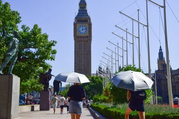 August 13, 2026, London, United Kingdom: People shield from the sun under umbrellas in a dry Parliament Square during the fifth heatwave of the year as drought conditions continue. London United Kingdom  - ZUMAs197 20260813_aaa_s197_072 Copyright: xVukxValcicx