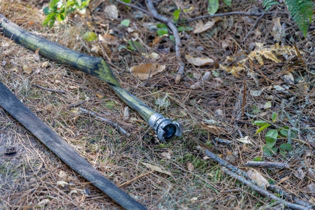 Forest Fire Aftermath In Saint-Just - France A burned firefighting hose lies on the ground during a forest fire in the Saint-Just area of Ille-et-Vilaine, France on August 13, 2026, as emergency crews battle the blaze. Photo by La Tuque Jaune ANDBZ ABACAPRESS.COM Saint-Just Ille-et-Vilaine France  Copyright: xANDBZ ABACAx