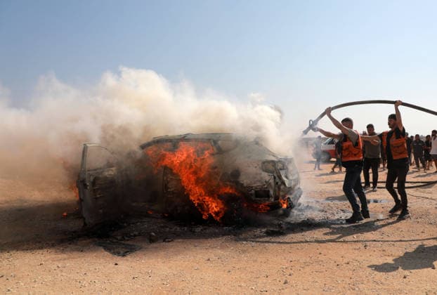 Palestinians Extinguish Vehicle Fire After Israeli Strike in Gaza City Palestinian Civil Defense members and displaced Palestinians work to extinguish a fire in a car following an Israeli strike on Al-Rashid Street, southwest of Gaza City, Gaza Strip, on August 13, 2026. Local sources said Jamal Abu Kamil, director of the Gaza Governorate police, was killed when his car was targeted in the Sheikh Ajleen neighborhood of southwest Gaza City. Photo by Ahmed Ibrahim apaimages Deir al-Balah Gaza Palestinian Territory 130826_Gaza_AI_00(9) Copyright: xapaimagesxAhmedxIbrahimx xapaimagesx