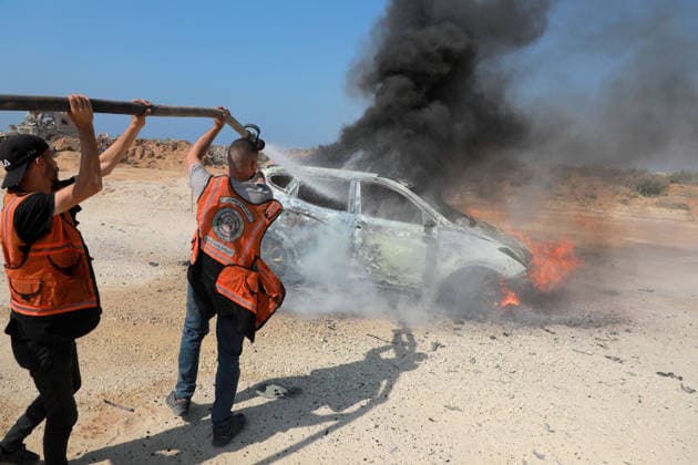 Palestinians Extinguish Vehicle Fire After Israeli Strike in Gaza City Palestinian Civil Defense members and displaced Palestinians work to extinguish a fire in a car following an Israeli strike on Al-Rashid Street, southwest of Gaza City, Gaza Strip, on August 13, 2026. Local sources said Jamal Abu Kamil, director of the Gaza Governorate police, was killed when his car was targeted in the Sheikh Ajleen neighborhood of southwest Gaza City. Photo by Ahmed Ibrahim apaimages Deir al-Balah Gaza Palestinian Territory 130826_Gaza_AI_00(2) Copyright: xapaimagesxAhmedxIbrahimx xapaimagesx