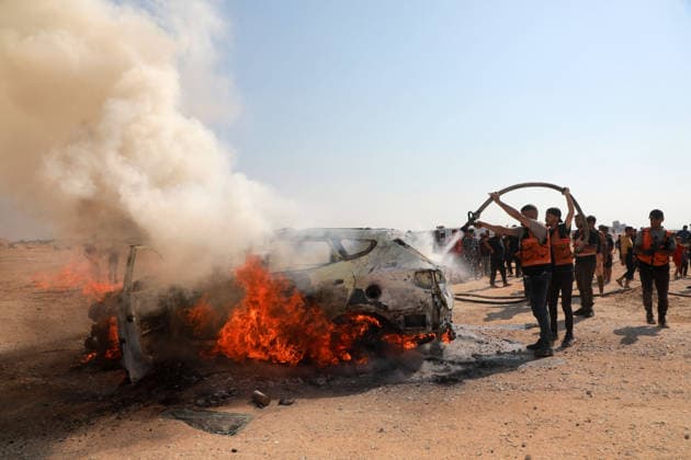 Palestinians Extinguish Vehicle Fire After Israeli Strike in Gaza City Palestinian Civil Defense members and displaced Palestinians work to extinguish a fire in a car following an Israeli strike on Al-Rashid Street, southwest of Gaza City, Gaza Strip, on August 13, 2026. Local sources said Jamal Abu Kamil, director of the Gaza Governorate police, was killed when his car was targeted in the Sheikh Ajleen neighborhood of southwest Gaza City. Photo by Ahmed Ibrahim apaimages Deir al-Balah Gaza Palestinian Territory 130826_Gaza_AI_00(7) Copyright: xapaimagesxAhmedxIbrahimx xapaimagesx
