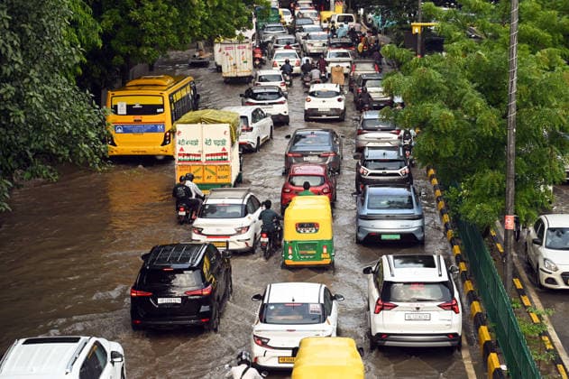 Heavy rain lashes parts of the National Capital New Delhi, Aug 13 (ANI): Commuters wade through a waterlogged road near SIR M. Vishweshwariah Moti Bagh metro station following heavy rainfall, in New Delhi on Thursday. New Delhi Delhi India Copyright: xANIx ANI_20260813275