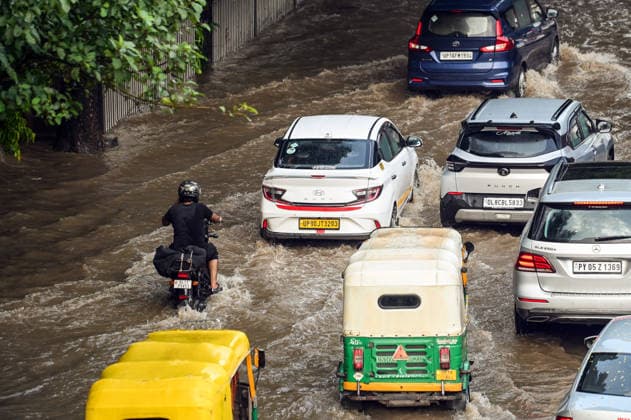 Heavy rain lashes parts of the National Capital New Delhi, Aug 13 (ANI): Commuters wade through a waterlogged road near SIR M. Vishweshwariah Moti Bagh metro station following heavy rainfall, in New Delhi on Thursday. New Delhi Delhi India Copyright: xANIx ANI_20260813283