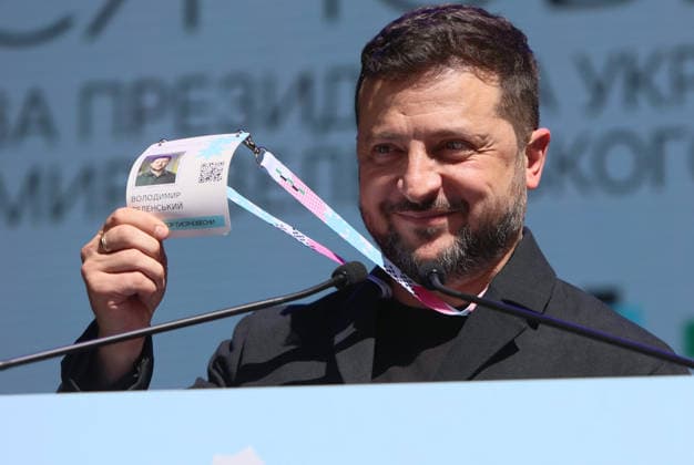 President of Ukraine Volodymyr Zelenskyy shows his name badge on a lanyard as he addresses participants in the final stage of selection for the National Tysiachovesna Initiative during a working visit to Ivano-Frankivsk, Ukraine, August 13, 2026. The Tysiachovesna (Thousand Springs) Initiative of the President of Ukraine is implemented by the Ministry of Culture and the Office of the President. It is designed to foster the creation of new, high-quality Ukrainian cultural products, with up to UAH 4 billion in state support allocated for its implementation. (Photo by Yurii Rylchuk Ukrinform) Ukrainian President addresses finalists of National Tysiachovesna Initiative  Copyright: xYuriixRylchukx