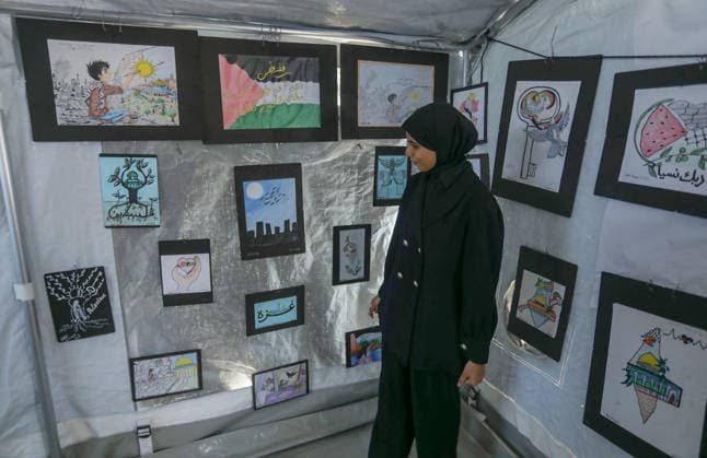 Palestinian children reflect war, displacement and hope through Art in Khan Yunis KHAN YUNIS, GAZA , PALESTINE - AUGUST 13: Works by Palestinian children are brought together in the exhibition held inside a tent at a refugee camp in the Al-Mawasi area of Khan Yunis, Gaza, Palestine on August 13, 2026. Created amid the severe humanitarian conditions resulting from the attacks that have continued since Oct. 2023, the artworks depict the children s experiences of displacement, destruction, hunger, water shortages and the loss of loved ones. Abed Rahim Khatib Anadolu Han Yunus Palestinian Territory, Occupied. Editorial use only. Please get in touch for any other usage.  Copyright: x2026xAnadoluxAbedxRahimxKhatibx