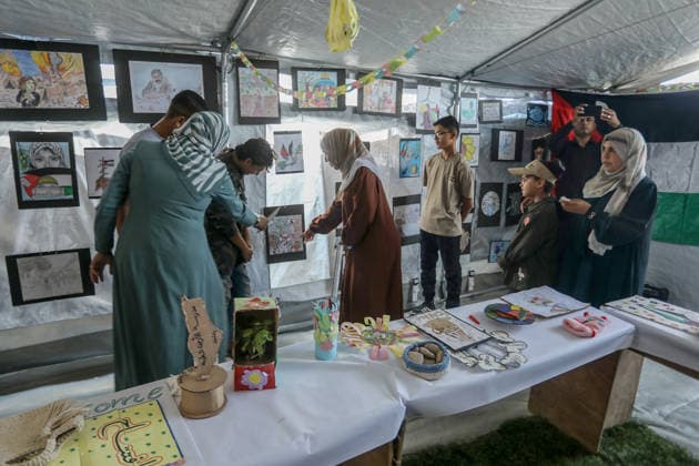 Palestinian children reflect war, displacement and hope through Art in Khan Yunis KHAN YUNIS, GAZA , PALESTINE - AUGUST 13: Works by Palestinian children are brought together in the exhibition held inside a tent at a refugee camp in the Al-Mawasi area of Khan Yunis, Gaza, Palestine on August 13, 2026. Created amid the severe humanitarian conditions resulting from the attacks that have continued since Oct. 2023, the artworks depict the children s experiences of displacement, destruction, hunger, water shortages and the loss of loved ones. Abed Rahim Khatib Anadolu Han Yunus Palestinian Territory, Occupied. Editorial use only. Please get in touch for any other usage.  Copyright: x2026xAnadoluxAbedxRahimxKhatibx