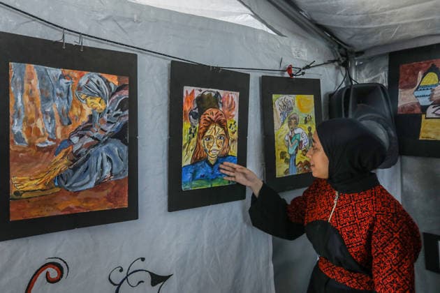 Palestinian children reflect war, displacement and hope through Art in Khan Yunis KHAN YUNIS, GAZA , PALESTINE - AUGUST 13: Works by Palestinian children are brought together in the exhibition held inside a tent at a refugee camp in the Al-Mawasi area of Khan Yunis, Gaza, Palestine on August 13, 2026. Created amid the severe humanitarian conditions resulting from the attacks that have continued since Oct. 2023, the artworks depict the children s experiences of displacement, destruction, hunger, water shortages and the loss of loved ones. Abed Rahim Khatib Anadolu Han Yunus Palestinian Territory, Occupied. Editorial use only. Please get in touch for any other usage.  Copyright: x2026xAnadoluxAbedxRahimxKhatibx