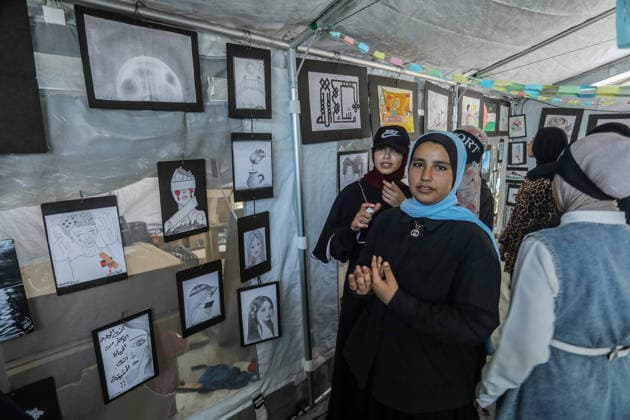 Palestinian children reflect war, displacement and hope through Art in Khan Yunis KHAN YUNIS, GAZA , PALESTINE - AUGUST 13: Works by Palestinian children are brought together in the exhibition held inside a tent at a refugee camp in the Al-Mawasi area of Khan Yunis, Gaza, Palestine on August 13, 2026. Created amid the severe humanitarian conditions resulting from the attacks that have continued since Oct. 2023, the artworks depict the children s experiences of displacement, destruction, hunger, water shortages and the loss of loved ones. Abed Rahim Khatib Anadolu Han Yunus Palestinian Territory, Occupied. Editorial use only. Please get in touch for any other usage.  Copyright: x2026xAnadoluxAbedxRahimxKhatibx